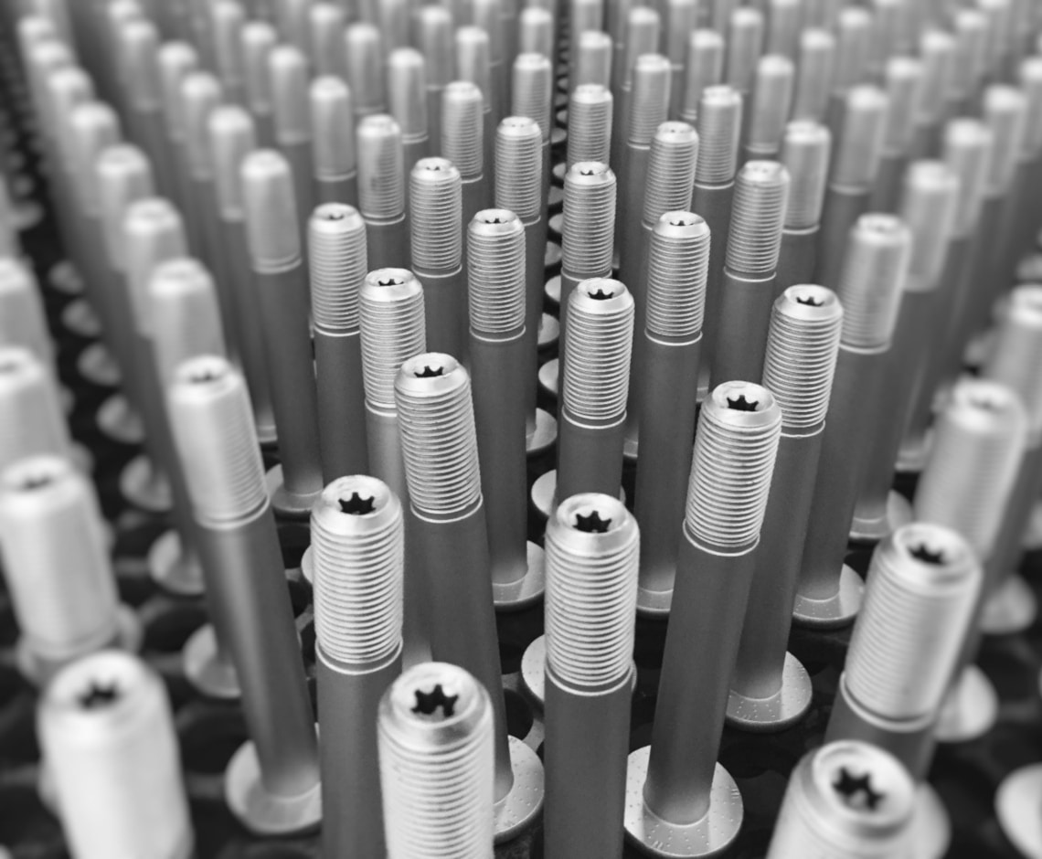 Treatment of screws in polymer